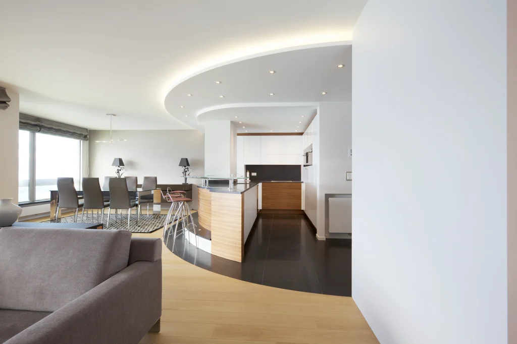 Vue d’ensemble d’une cuisine conçue par Renov Management architecte d’intérieur avec lignes courbes et open space